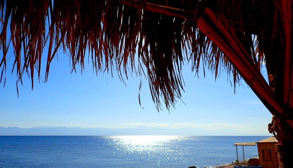 Feel the energy of the sun playing with the sea in front of the  beach