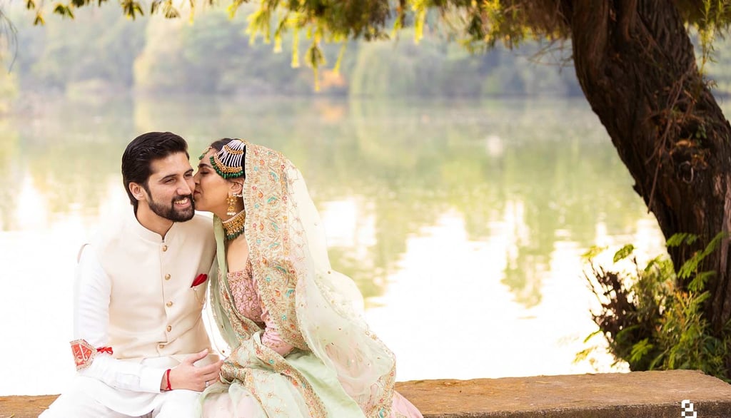 a man and woman in traditional indian wedding attire