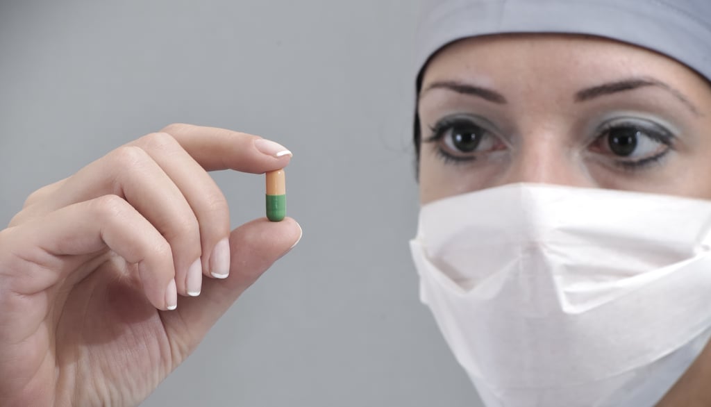 Scientist holding pill
