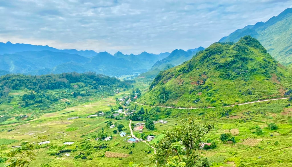 a mountain view of a valley with a road and a road