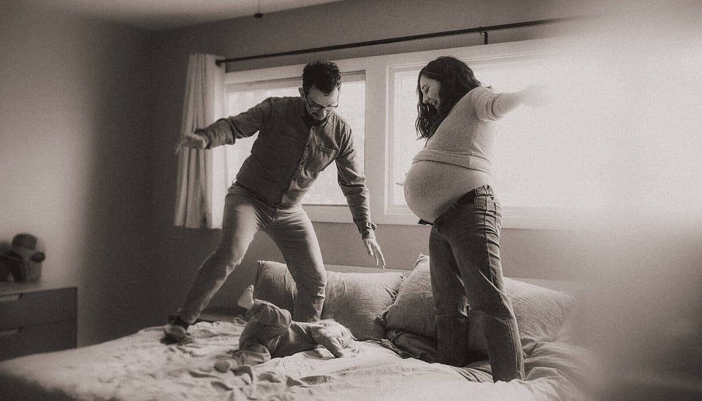 black and white photo of Duluth family playing on bed during in-home maternity session