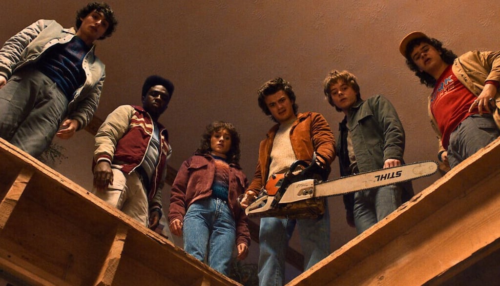 Stranger Things Season 5 characters standing around a dip looking down