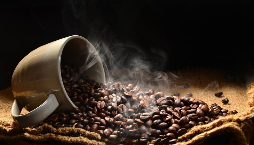 A cup with roasted coffee beans