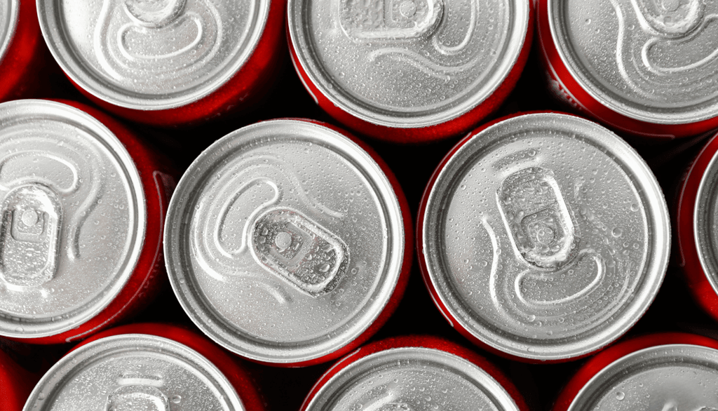 Top view of cold Coca-Cola cans with condensation — used to show recalled soda products affected by the FDA contamination ale