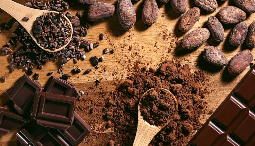 a wooden table with chocolate and cocoa beans