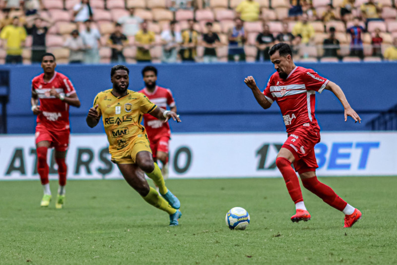 a soccer player is running with the ball