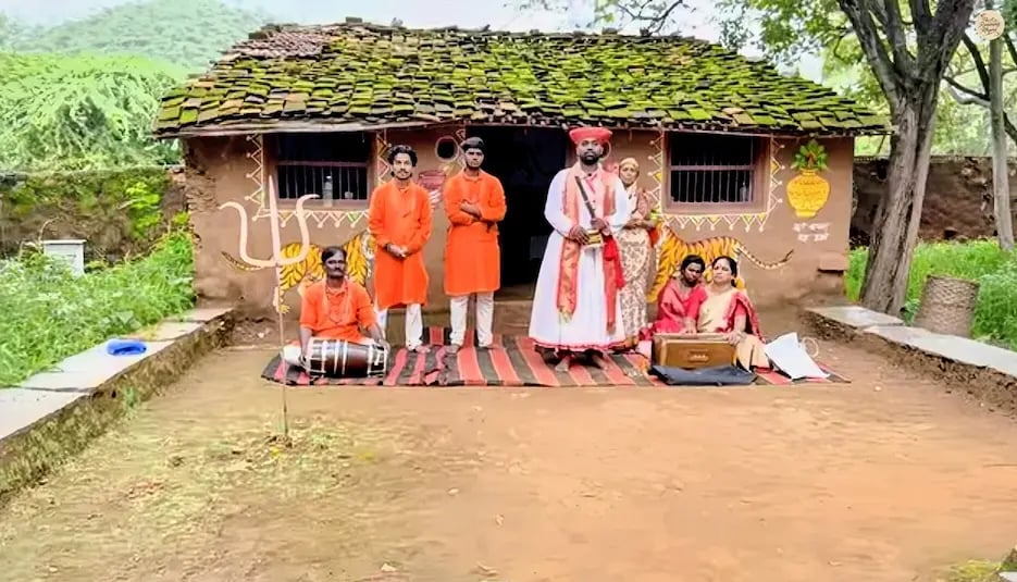 Folk artists dressed in colorful attire before a dance show at Shilpgram craft village.