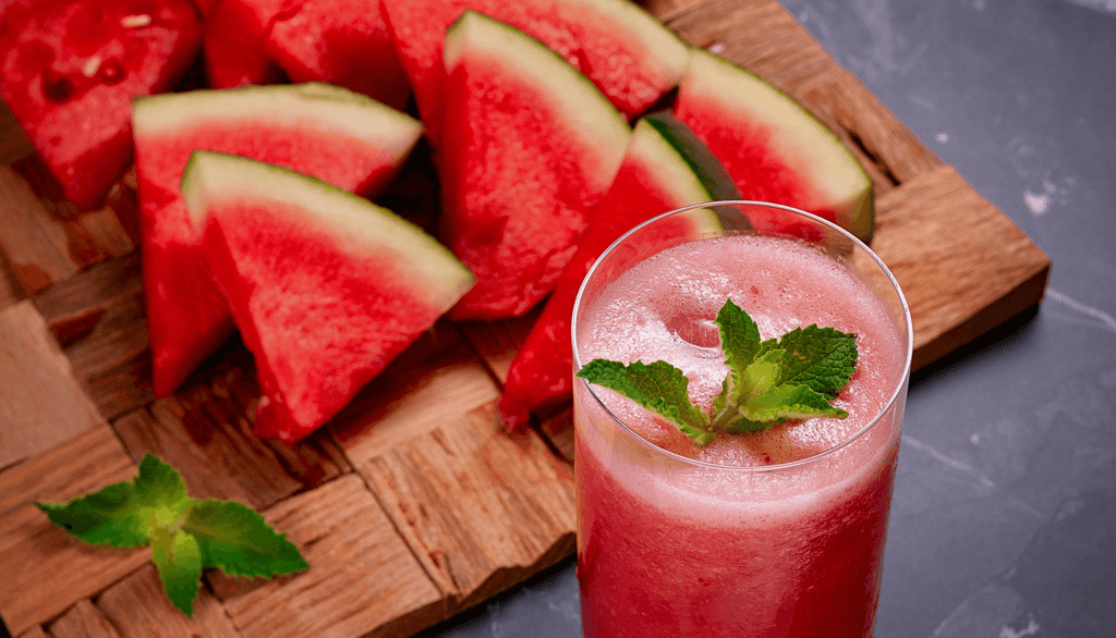 a glass of watermelon with a slice of watermelon