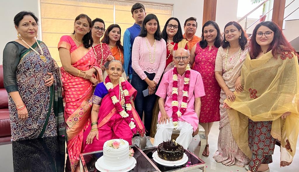 a group of people standing around a cake