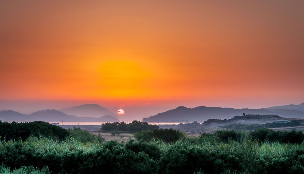 a sunset over a mountain range