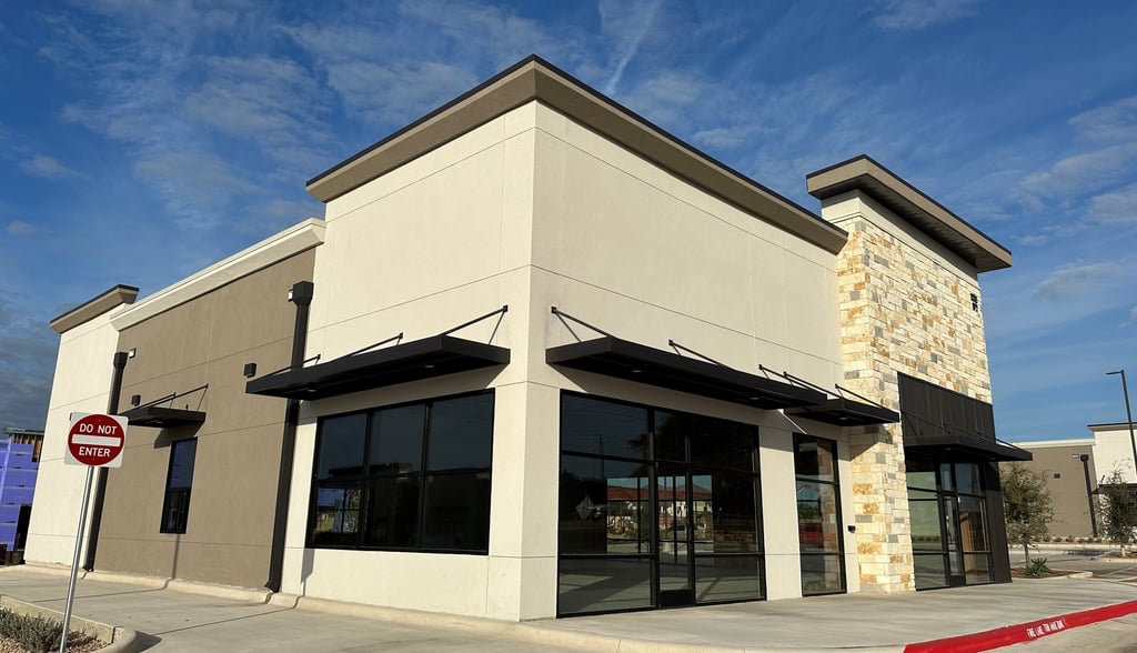 Commercial building with two tones of stucco colors and Texas Mix limestone in a random ashlar.
