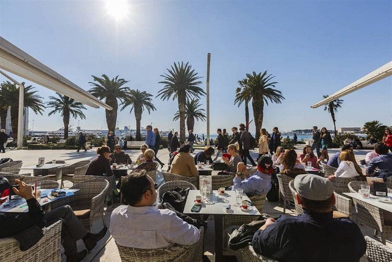 People drinking coffee on the Riva promenade in Split, Croatia