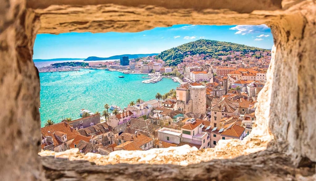 View of Split, Croatia through ancient stone window overlooking the old town and Adriatic Sea