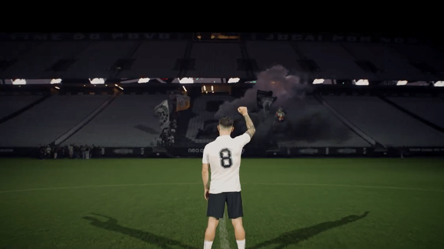 a man holding a soccer ball in front of a stadium, Rodrigo Garro