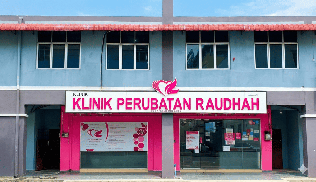 Exterior of Klinik Perubatan Raudah medical clinic building with pink signage and glass storefront.
