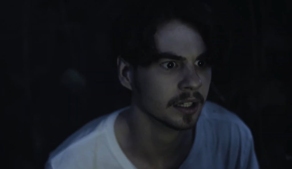 a man with a mustache and a white shirt