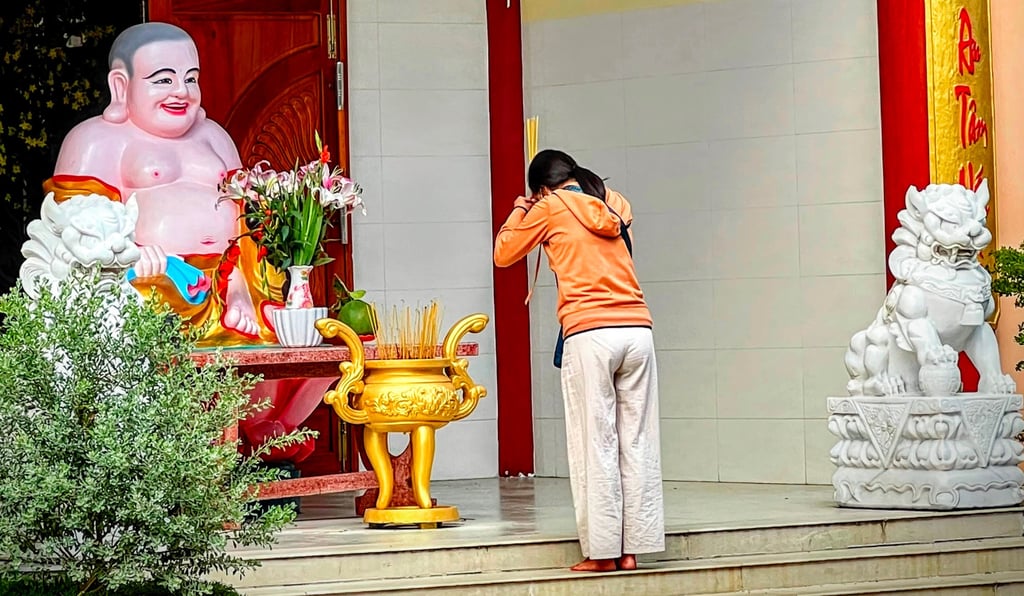Woman making incense offering at q pagoda, Soc Trang, Vietnam