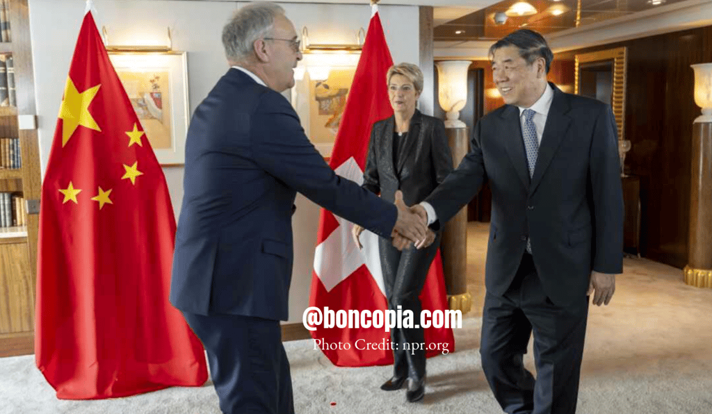 a man in a suit and tie is shaking hands with a woman in a suit