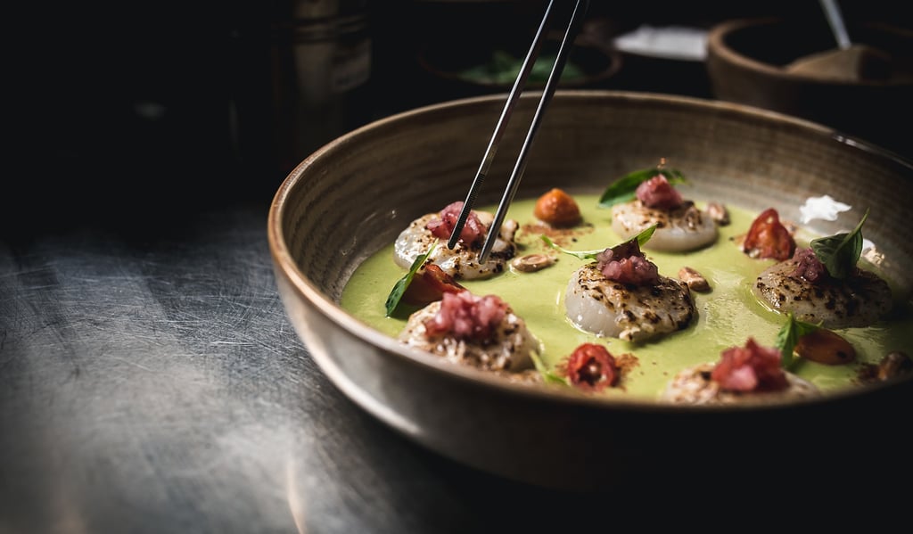 a bowl of food with chopsticks and chopsticks