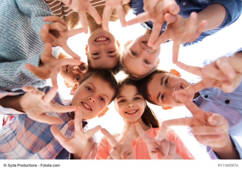 a group of people standing in a circle with their hands up