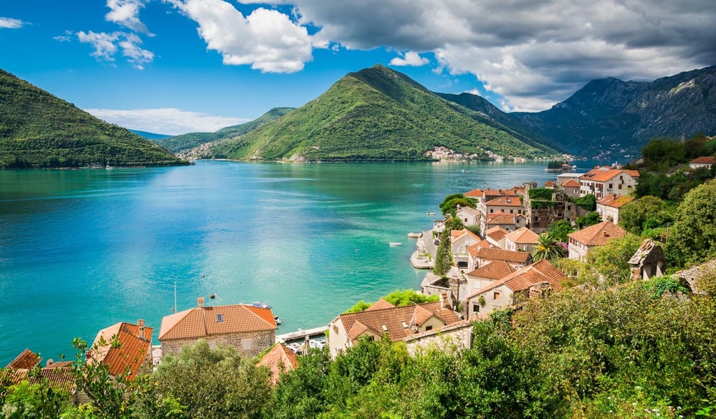 Panoramic view of the historic town of Perast on the Bay of Kotor in Montenegro with scenic mountains.