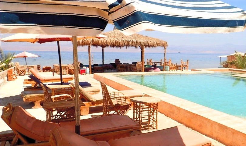 Bedouin star ras shitan lounging under the umbrella