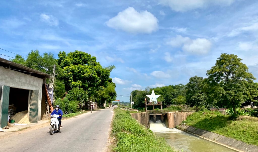a person riding a motorcycle down a narrow road