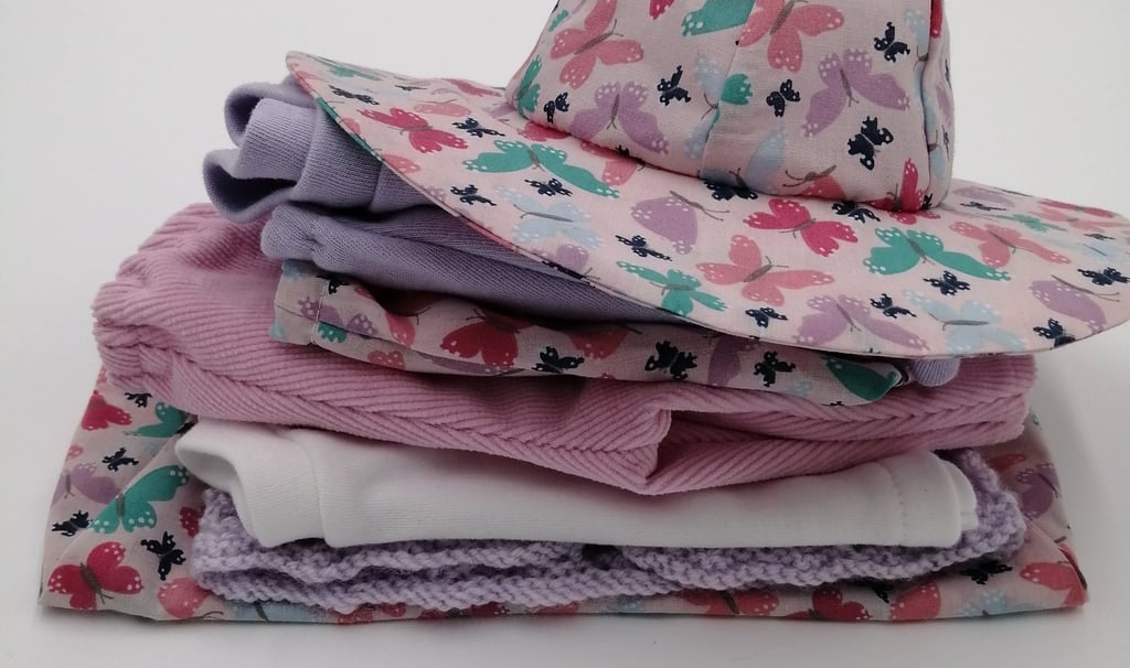 A pile of dolls clothes