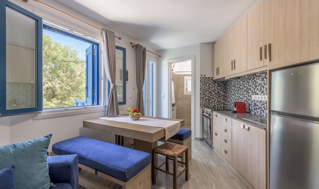 a kitchen with a table and chairs and a refrigerator