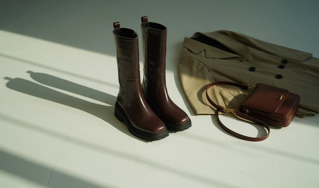 a pair of boots and a purse on a table