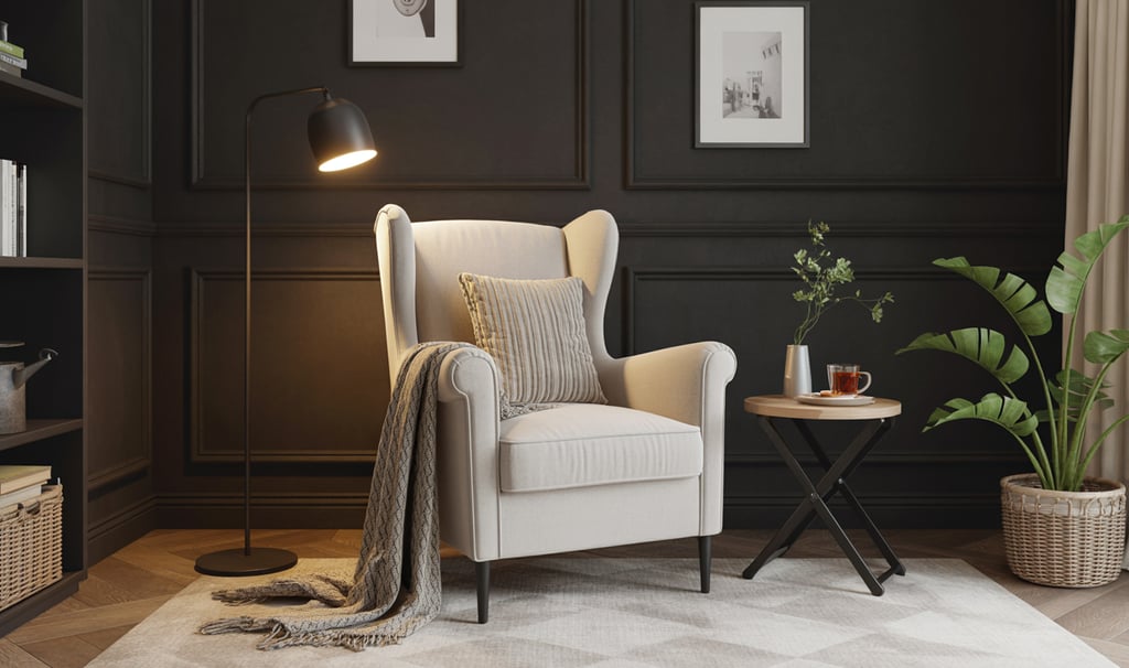 a chair with a blanket on it and a lamp on the side of a table