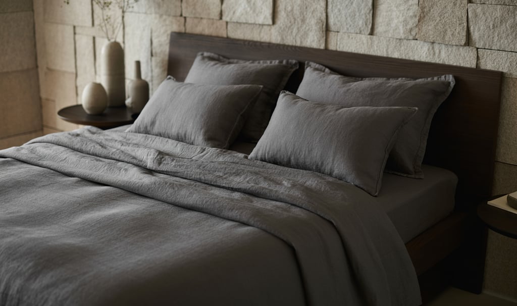 a bed with a large bed and a vase with flowers