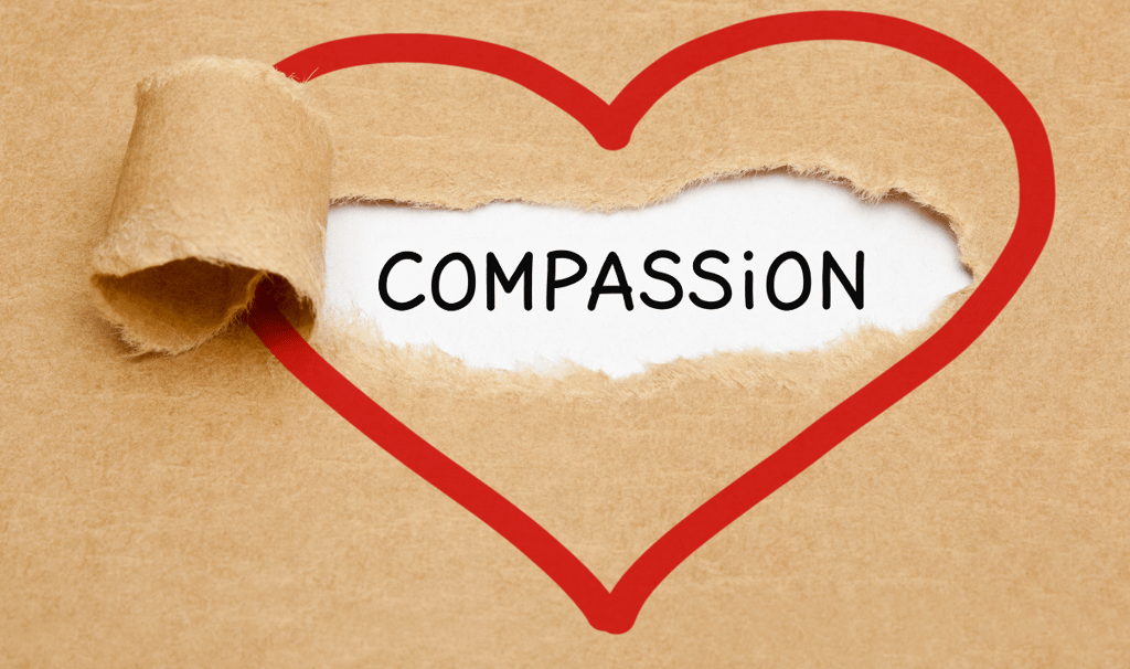 a heart shaped with the word compassion inside