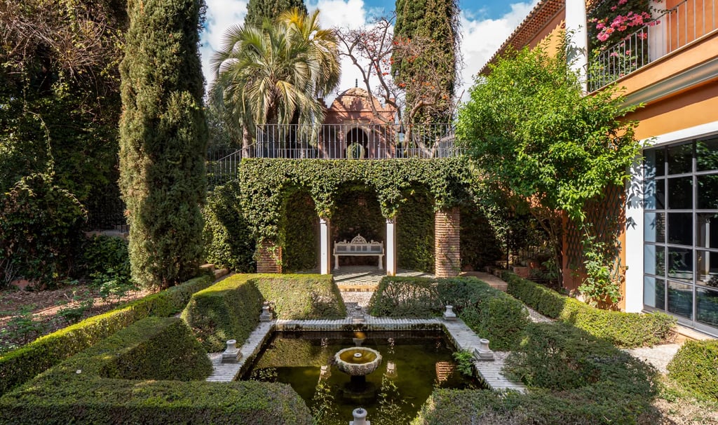 Formal courtyard garden with fountain and manicured hedges
