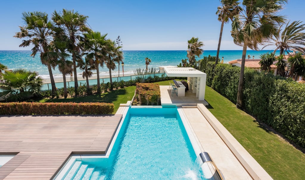 Beachfront pool and garden with outdoor bar pavilion