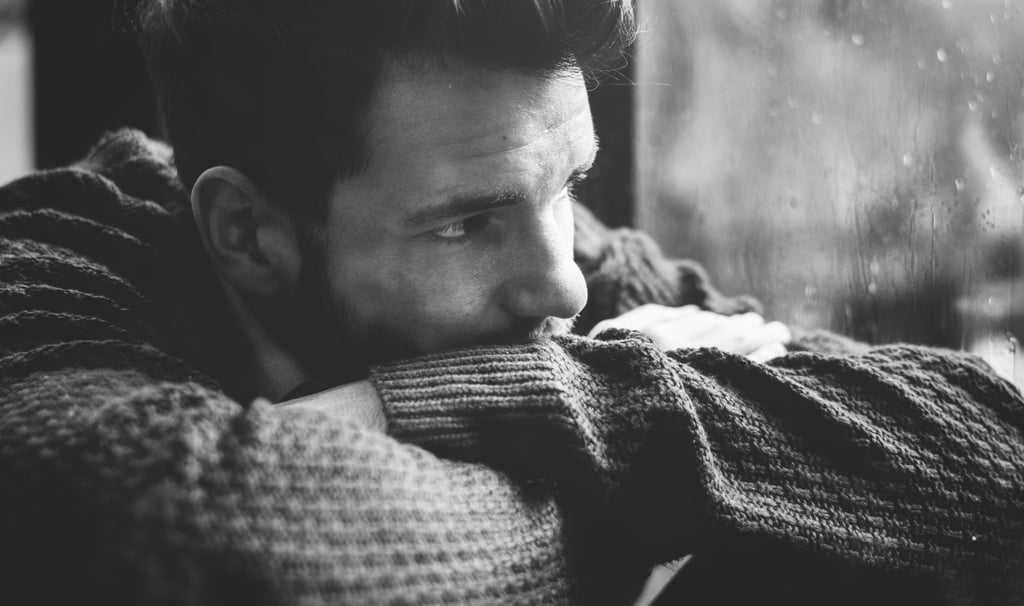 depressed man looking out the window