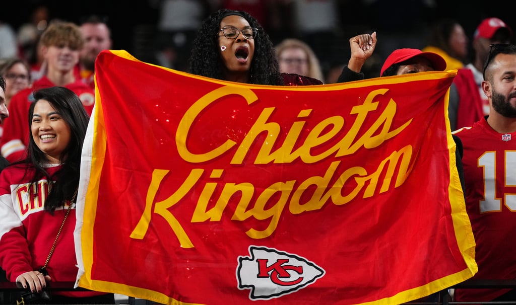 Kansas City Chiefs Fan holding "Chiefs Kingdom" Flag