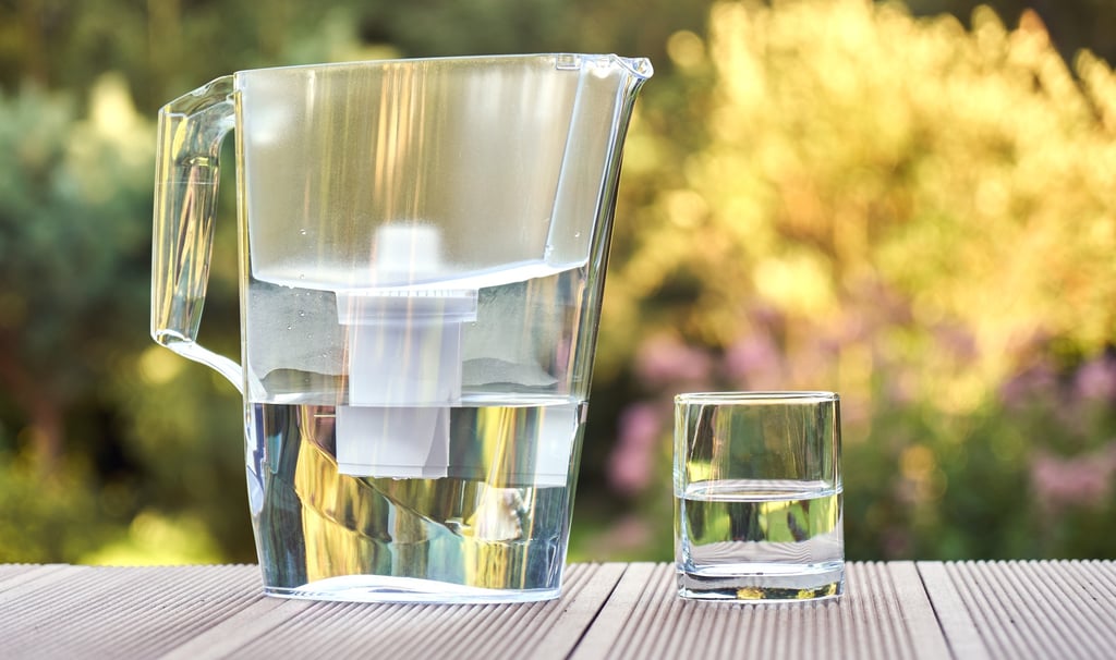 Eco-friendly water filter pitcher with a clean glass of water, sustainable alternative to bottled wa