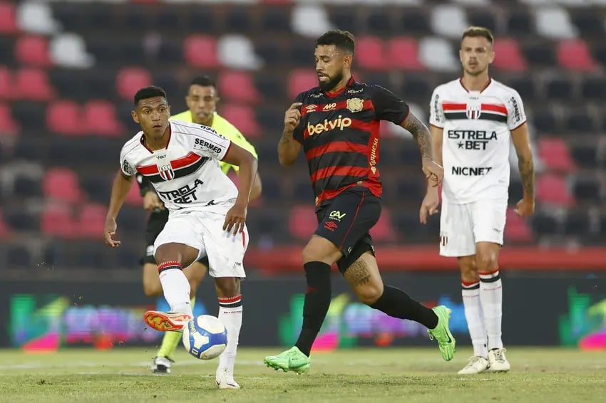 a soccer player is running with the ball