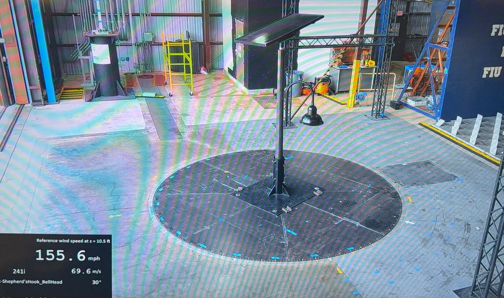 A solar panel street light undergoing high-velocity wind tunnel testing at the FIU Wall of Wind facility.