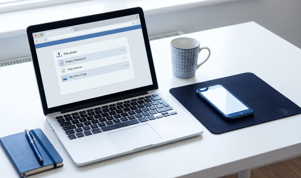 Person fixing file name upload errors on a laptop before submitting documents online