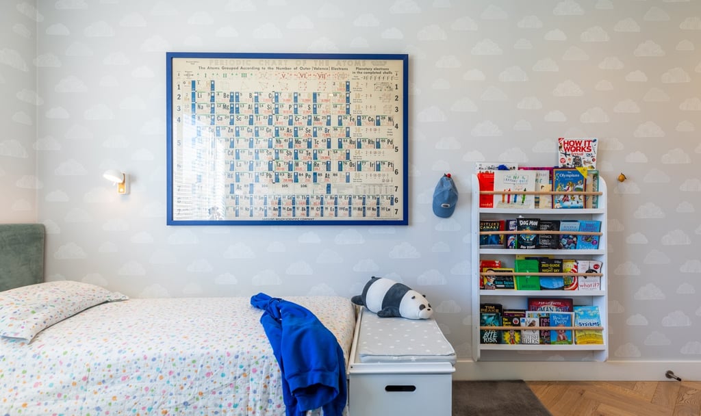 a kid's bedroom with a bed and a book shelf