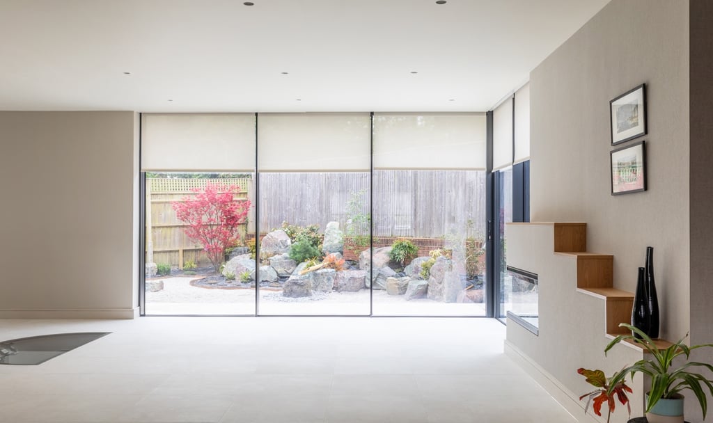 a dining room with a fireplace and full ceiling to floor sliding doors