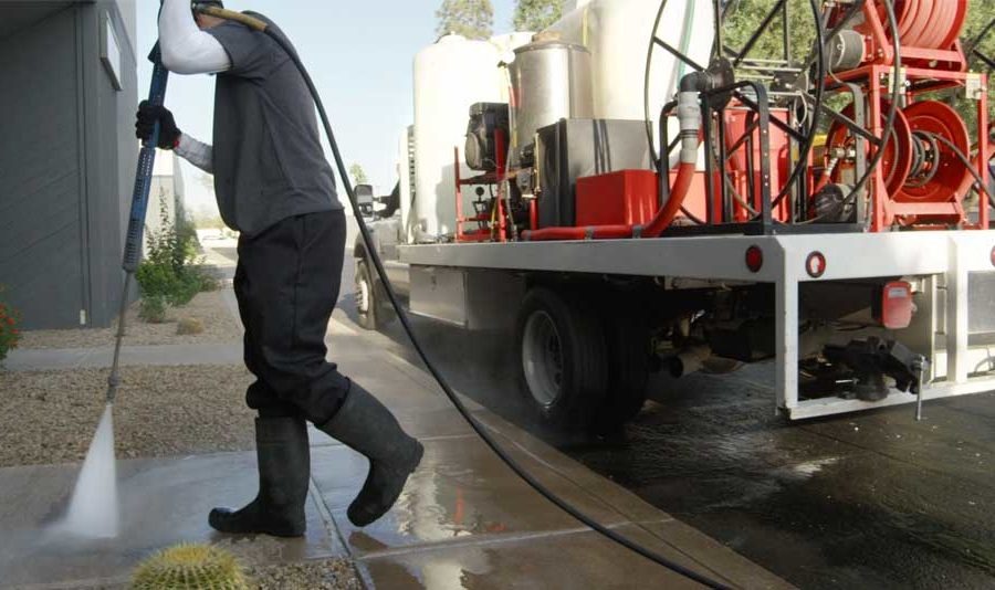pressure washing services pressure washer worker cleaning commercial walkway