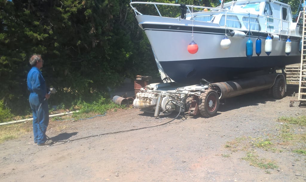 Henri moving our old boat NjivaI before relaunching it.boa