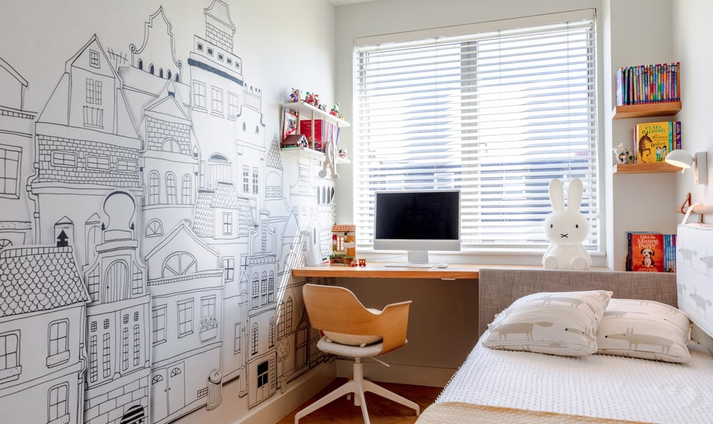 a small bedroom with bespoke headboard attached to a desk with maximised storage 