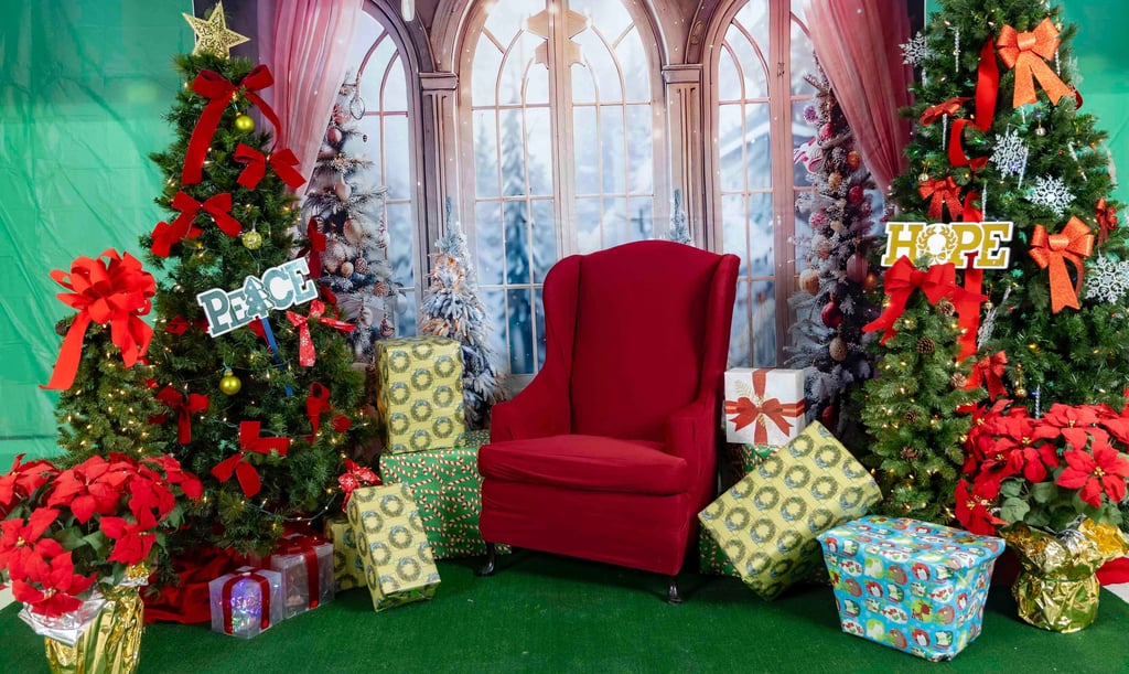 a christmas tree with presents and presents on a green background