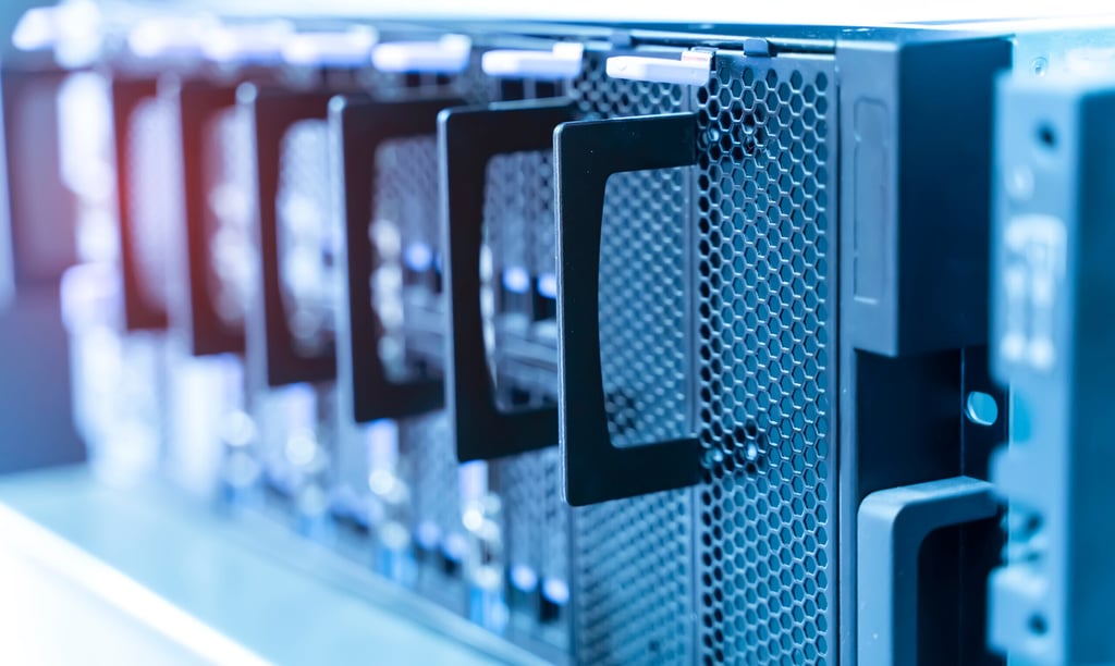 Close-up of server rack hardware with drive bays in a high-tech data center room.