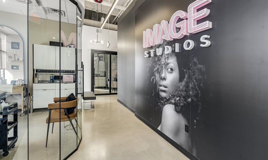 Modern salon interior at Image Studios featuring luxury private beauty suites and sleek glass walls.