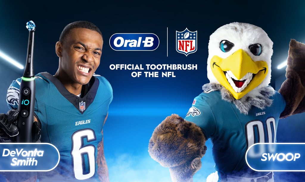 a man in a green uniform with a mascot 